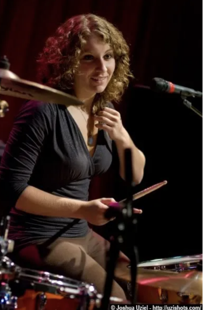 Lily Ray (formerly Lily Faden) as the drummer in Two Seconds